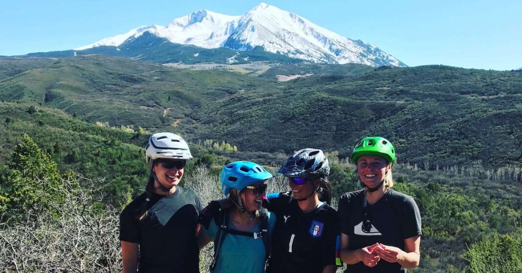 women mountain biking at base of Mt Sopris in Carbondale, Colorado